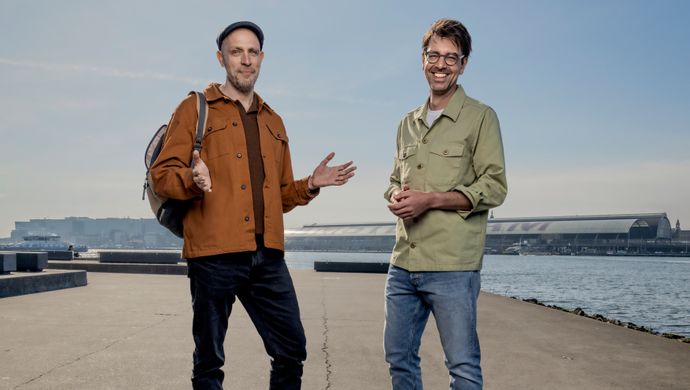 De heren Ruben Terlou en Jelle Brandt Corstius staan naast elkaar op een dijk. 